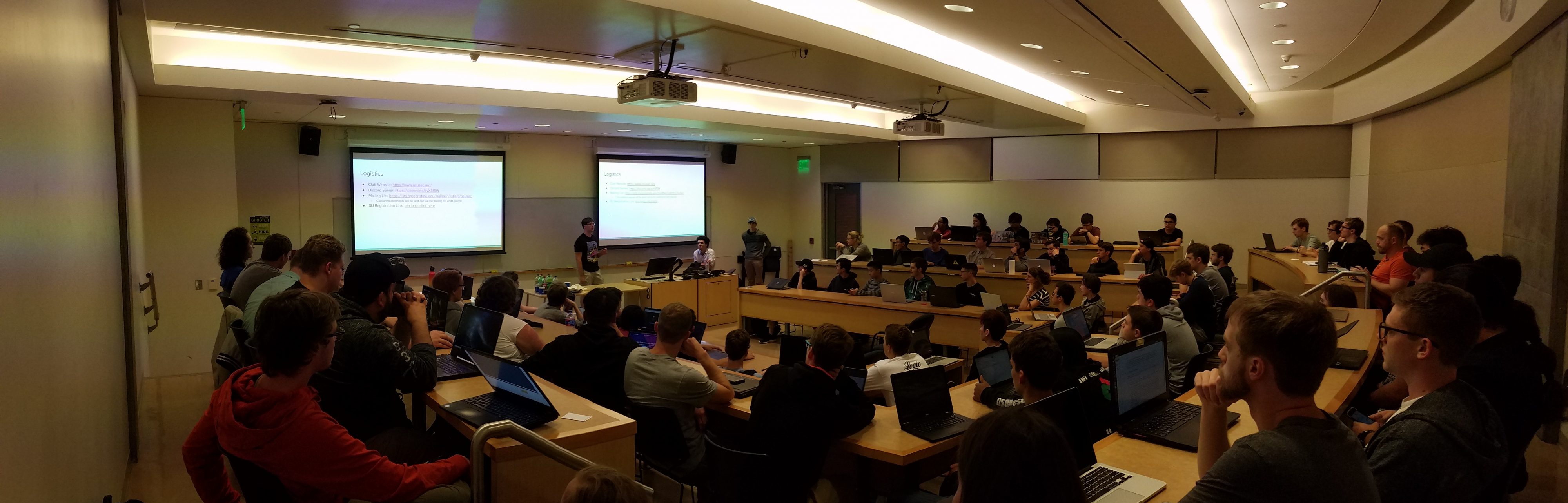 Image of a classroom full of students, many students have their laptops out