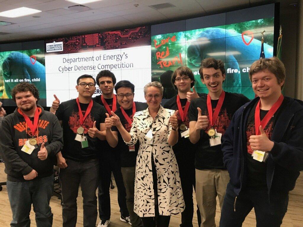 Victory photo of 6 OSUSEC students, Yeongjin Jang, and the director of the Cyberforce program.